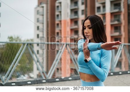 Woman doing workout alone on a roof