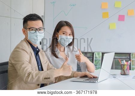 Business Employees Wearing Mask During Work In Office To Keep Hygiene Follow Company Policy.preventi