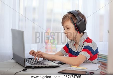Portrait Kid In Headphones Typing On Computer, Studying In Home. Education Knowlege, Technology Inte