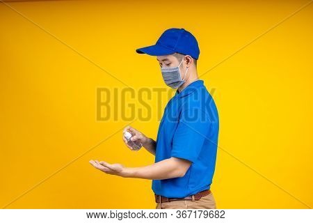 Asian Deliveryman Spry The Alcohol To Hand Before Get The Box During The Outbreak Of The Coronavirus
