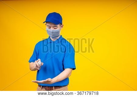 Asian Deliveryman Spry The Alcohol To Hand Before Get The Box During The Outbreak Of The Coronavirus