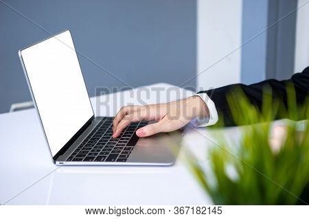 Asian Business Man Dringking Coffee Wearing Suit, Enjoying Watching Educational Webinar On Laptop Or