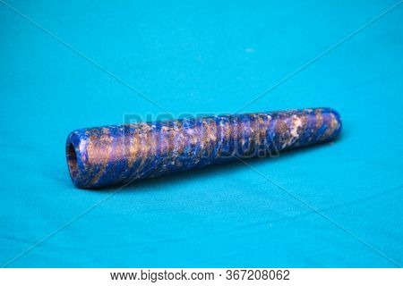 Clay Chillum For Marijuana Smoking On A Blue Fabric Background