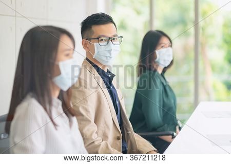 Business Employees Wearing Mask During Work In Office To Keep Hygiene Follow Company Policy.preventi