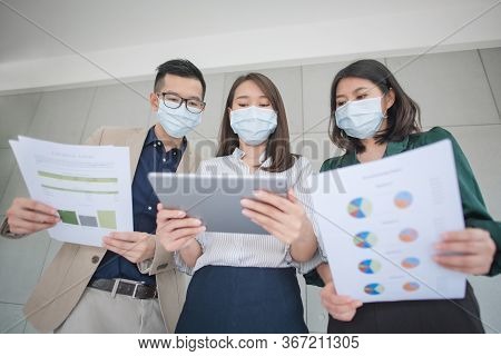 Business Employees Wearing Mask During Work In Office To Keep Hygiene Follow Company Policy.preventi