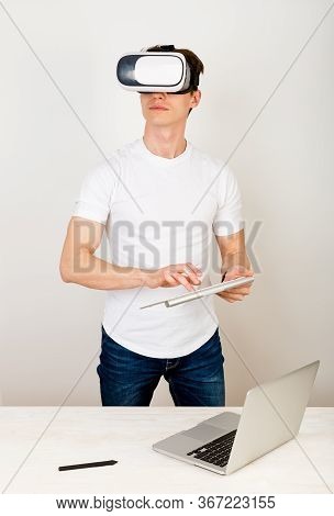Male Using Virtual Reality Headset Interacts With Augmented Things Orienting In Three Dimensional Sp