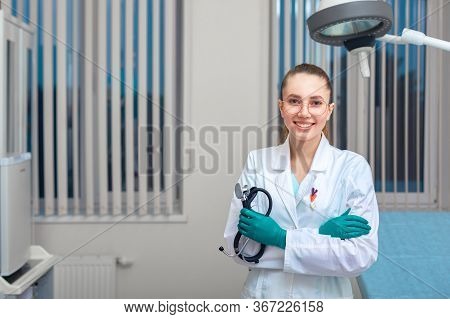 Portrait Of A Doctor Looking At The Camera. A Young Woman Is Smiling. Health Care, Medical. Combined