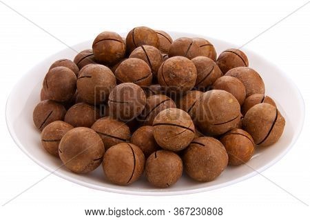 Delicious Macadamia Nuts On A Plate On A White Background