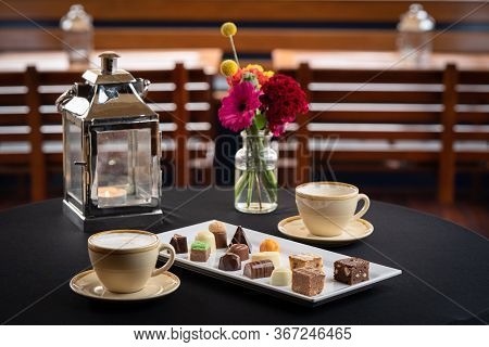 Mix Of Chocolates On A Table With Black Background, Confectioners Assortment Of Bon Bon Candies