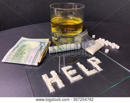 Pills; Us Dollar Banknotes; Whiskey And Cocaine; On A Gray Background. Stop Drugs Concept. A Word 