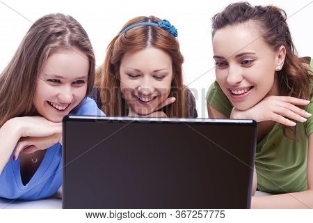 Youth Lifestyle. Portrait Of Three Happy And Laughing Caucasian Girlfriends Working With Laptop Indo