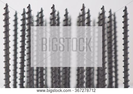 Background Of Self-tapping Screws, Black And Long, Standing Upright. Copyspace. Reduced Contrast. Ha