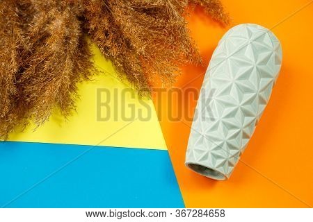 A Minimalistic Composition Of A Light Turquoise Ceramic Vase, Lies An Empty Vase On A Colored Backgr