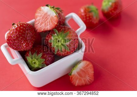 Red Fresh Strawberry Berries In White Ceramic Dishes On A Colored Background, Copyspace