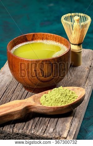 Japanese Green Matcha Tea In Wooden Cup, Matcha Powder In Wooden Spoon And Bamboo Whisk For Whipping