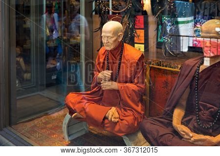 Barcelona, Spain - May 15, 2017: Statues Of The Tibetan Monks Near In The Showcase Of The One Of Ori