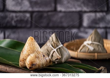 Rice Dumpling, Zongzi - Chinese Rice Dumpling Zongzi On Black Brick Background Slate Table, Concept