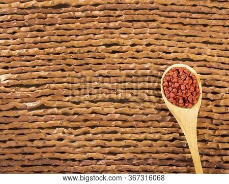 Organic Achiote Seeds - Bixa Orellana. Wood Background