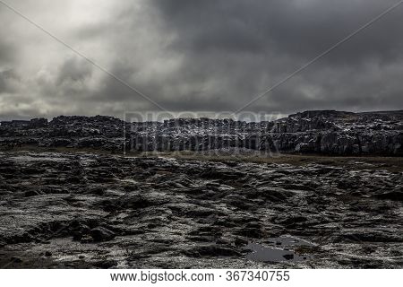 General View Of The Desert Near The Detifoss Waterfall In The North Of Iceland. The Sky Is Cloudy. T