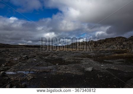 General View Of The Desert Near The Detifoss Waterfall In The North Of Iceland. The Sky Is Cloudy. T