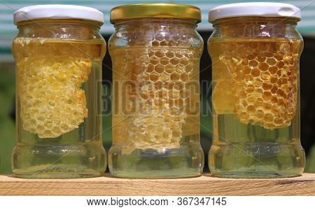 Three Honey Jars For Sale. Honey Is A Sweet, Viscous Food Substance Made By Honey Bees And Some Rela
