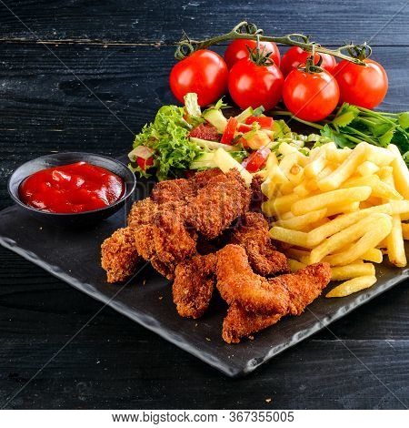Fried Chicken, Nuggets And French Fries, Set Of Chicken Nuggets, Salad And French Fries On Wood Tabl