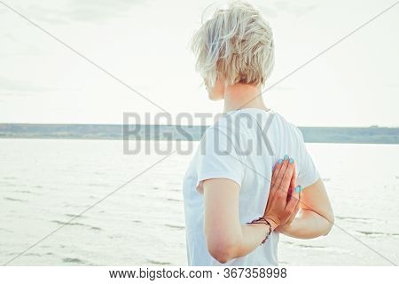 Young  Woman   Doing Morning Exercises On Coast  In Summer. Posture With Arms Folded Behind His Back