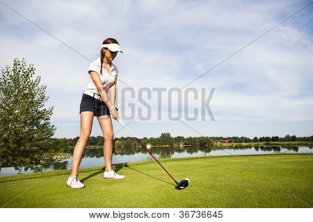 Meisje golf tee-het player zich te concentreren op de golfbal voor Tee.