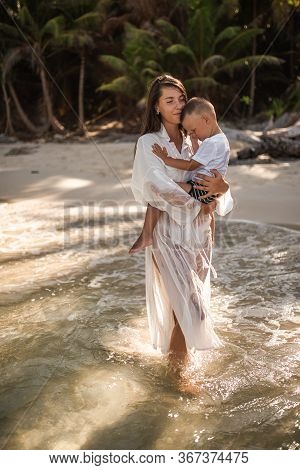 Happy Smile European Family Have Rest And Run On White Sand Beach