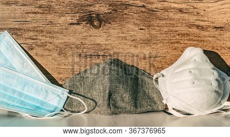 Types of masks for Coronavirus mask wearing: Different PPE protection for COVID-19 : reusable homemade cloth wear, disposable medical mask, n95 respirator for healthcare workers banner background.