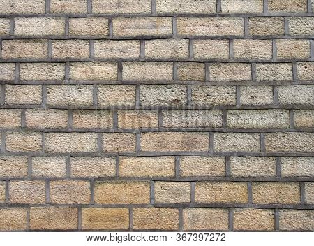 A Full Frame Image Of An Old Yellow Sandstone Wall Made Of Regular Blocks