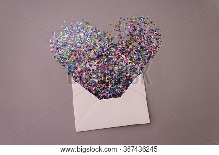 Opened White Envelope With Multicolored Sparkle Glitter Confetti Letters In Shape Of Heartt On Paste