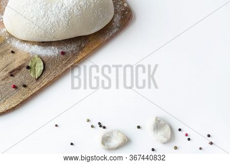 The Dough, Cut Into Pieces, Lies On A Table In Flour. Near A Large Piece Of Dough On The Board. Dump