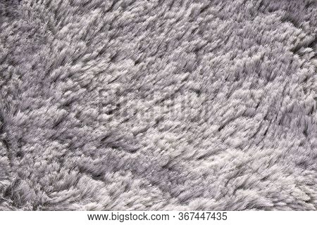 Artificial Fur Texture For Background Close-up. Fluffy Grey Material Backdrop. Kids Toys Faux Fur Te