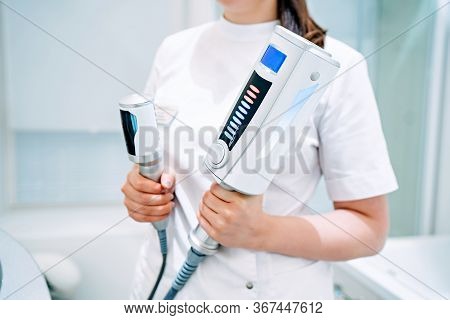 Cosmetologist Holds In Hands An Endosphere Therapy Apparatus, For Face And Body