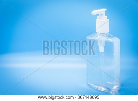 Clear Hand Sanitizer Keychain Isolated On A Blue Background.