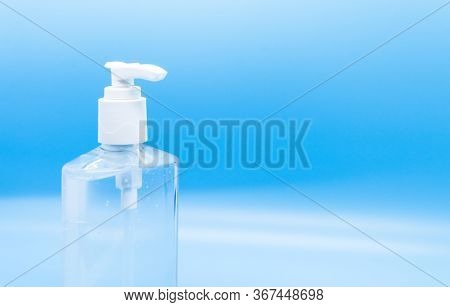 Clear Hand Sanitizer Keychain Isolated On A Blue Background.