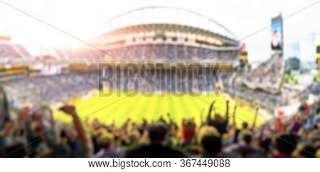Fans In Full Stadium Celebrate There Goal In Open Air Roof Stadium In Summer.  -blurred Technique.