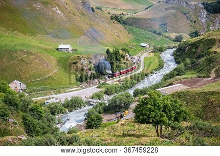 Realp, Furka - July 15, 2018: The Vintage Steam Train Going Through The Raelp Valley In Canton Uri, 