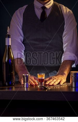 Bartender Serving Layered B52 Cocktail While Working In A Nightclub