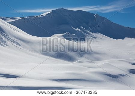 Snowcapped Sandhubel Mountain Near Arosa In Winter Snowscape And Blue Sky