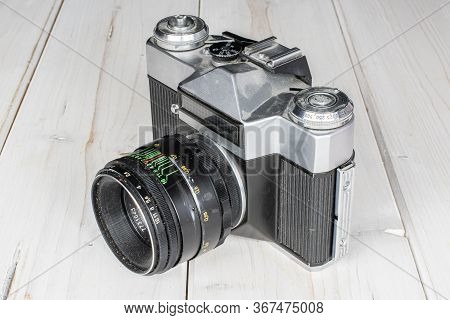 One Whole Vintage Camera On White Wood