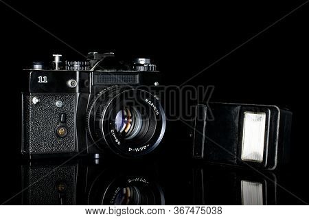 One Whole Camera With Flash Isolated On Black Glass