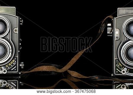 Group Of Two Whole Arranged Vintage Camera Isolated On Black Glass