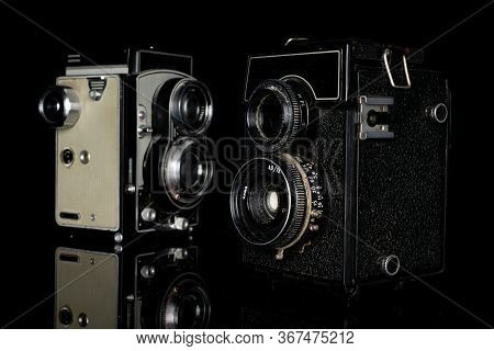 Group Of Two Whole Arranged Vintage Camera Isolated On Black Glass