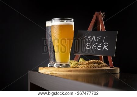 Two Types Of Craft Beer Served In Glasses On A Bar Counter; Glasses Of Cold Unfiltered Wheat Beer An