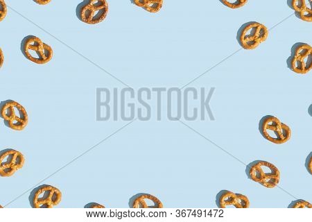 Crunchy Brezeln Or Salted Pretzel On Blue Background With Copy Space For Text. Top View, Flat Lay. T