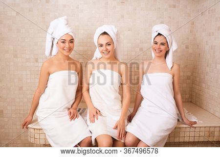 Three Girlfriends Sitting In A Hammam. Oriental Baths, Woman Relax In A Hammam. Spa Women Weekend