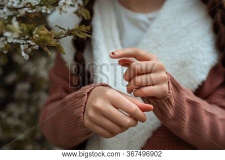 Girl In Blooming Cherry Garden On Beautiful Spring Day