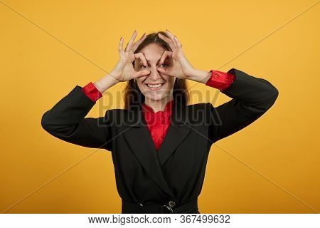 Young Attractive Brunette Woman In Black Stylish Suit, Red Shirt On Yellow Background, Funny Girl Ho
